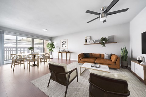 a living room with a couch and chairs and a dining room table